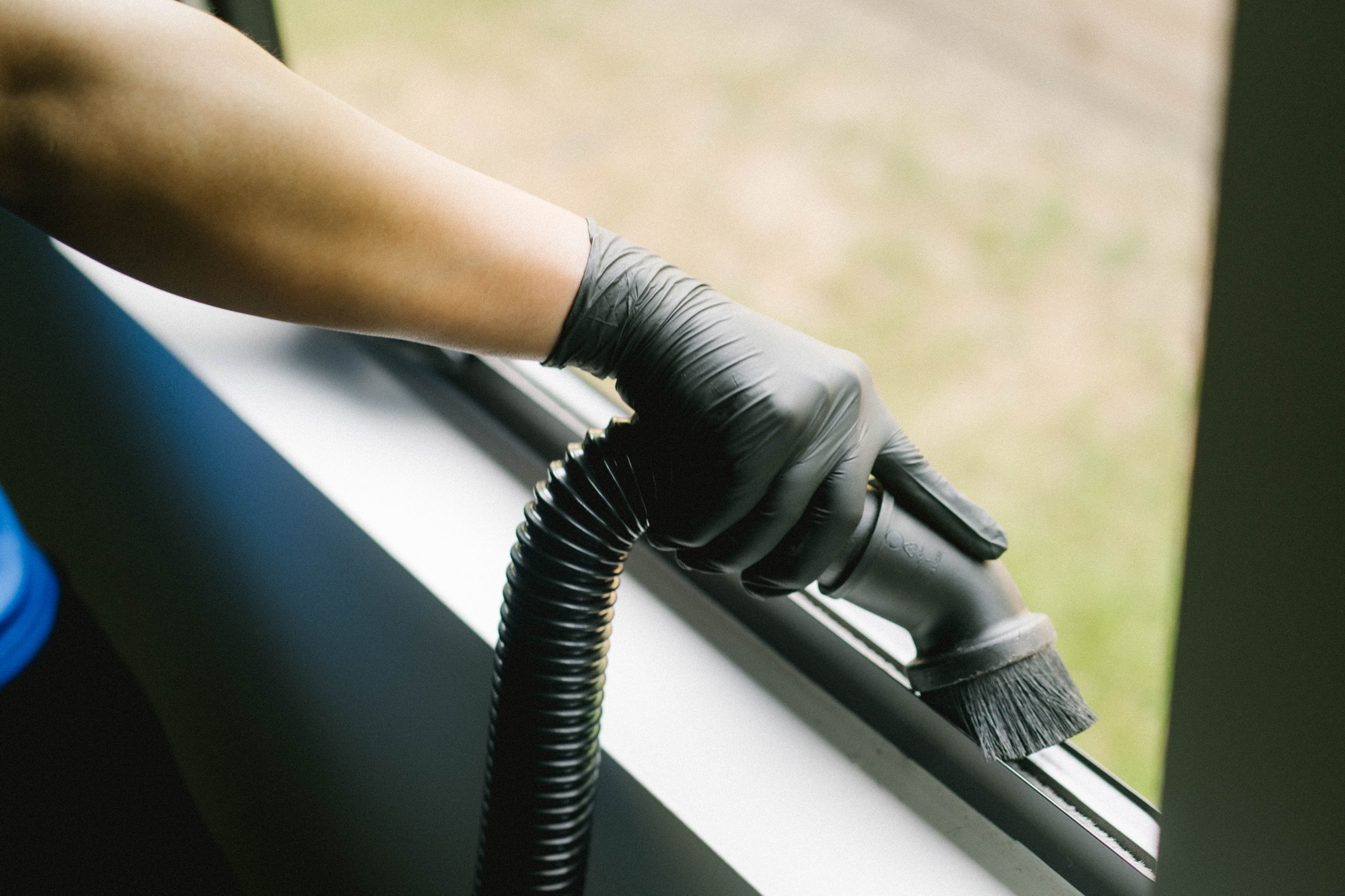 Detailing a window track with a brush and vacuum tool